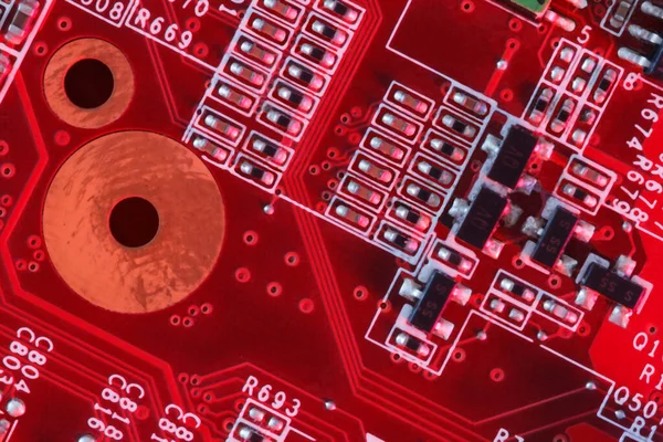 Electronic Printed Circuit Board in red with Electronic components viewed from above