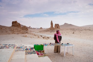 Bedouin selling handcrafts at the site of the  ancient city of Palmyra, Syrian Desert clipart