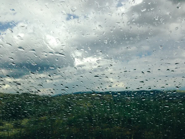 Background of rain drops on a window glass in a rainy day — Stock Photo, Image