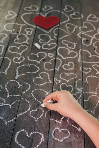 Love hearts drawing on a wooden background