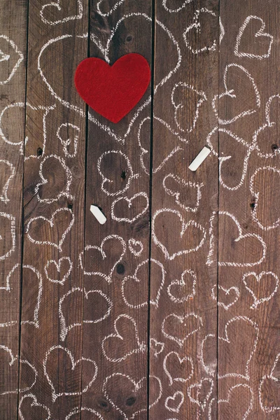 Love hearts drawing on a wooden background