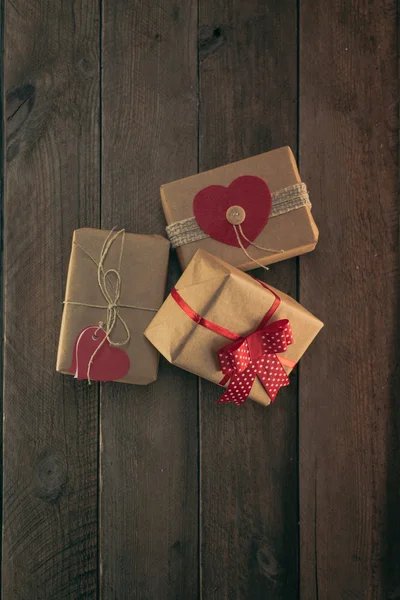 Stack of handcraft gift boxes on a wooden table — Stock Photo, Image