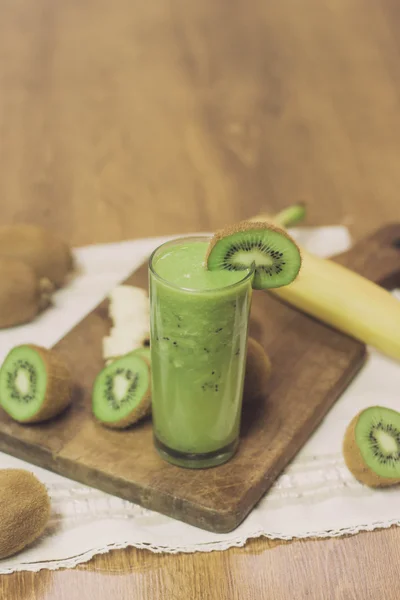 Green kiwi smoothie on wooden table — Stock Photo, Image