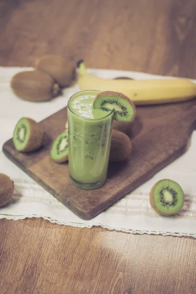 Green kiwi smoothie on wooden table — Stock Photo, Image