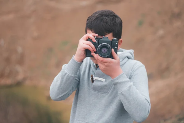 Young boy shooting with vintage camera — Stock Photo, Image