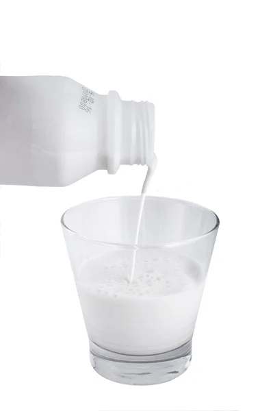 往玻璃杯中倒入鲜牛奶 — 图库照片