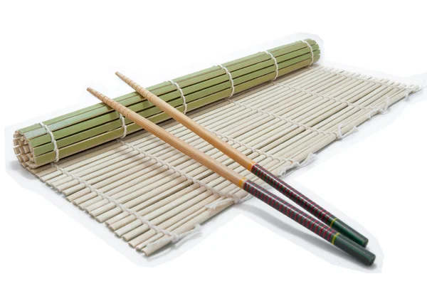Two chopsticks on a bamboo mat background — Stock Photo, Image