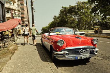 CUBA, HAVANA-JUNE 27, 2015: Classic american car on a street in Havana. Cubans use the retro cars as taxis for tourists clipart