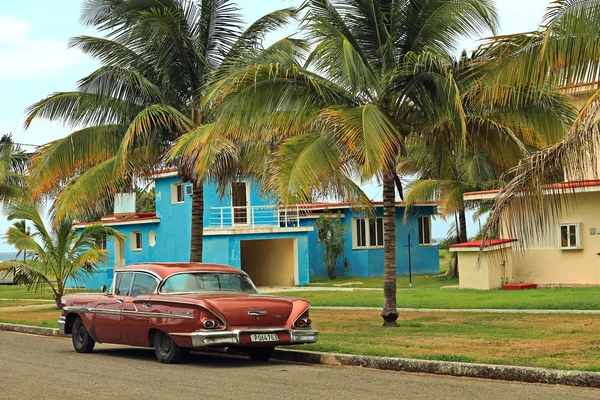 HAVANA, CUBA - JULY 6, 2015: American red car parked under palms near the Tarara  beach. — Stock Photo, Image