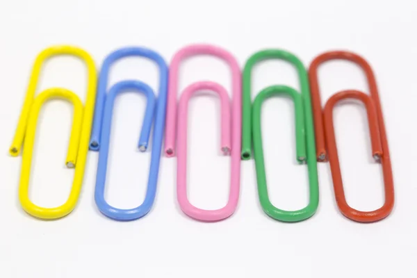 Colored paper clips on a white background — Stock Photo, Image