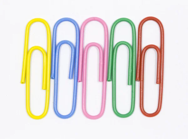 Colored paper clips on a white background — Stock Photo, Image