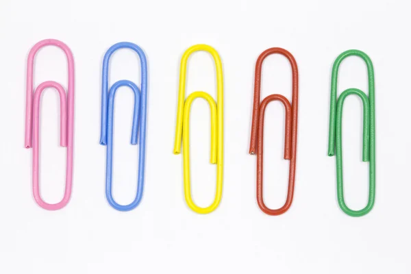 Colored paper clips on a white background — Stock Photo, Image