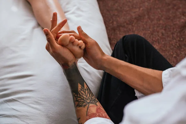 Stock photo of unrecognized person enjoying foot massage in spa.