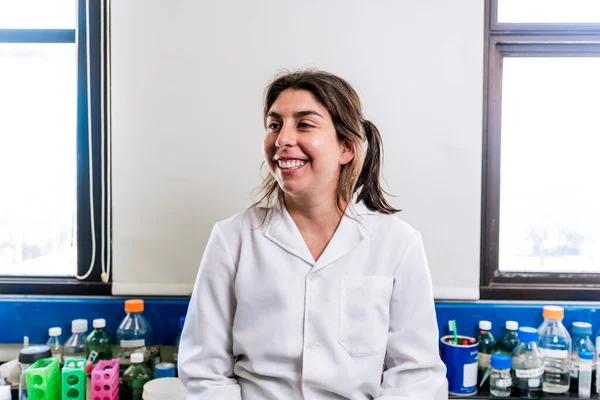 Close up portrait of female scientist smiling in the laboratory.