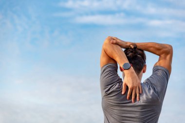 Genç latin adam dışarıda egzersiz yaptıktan sonra geriniyor.