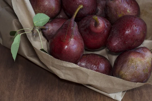 Ripe red pear on a wooden table