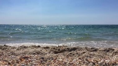 Denizin kıyıdan dalgaları ile açık güneşli bir günde görüntüleyin.