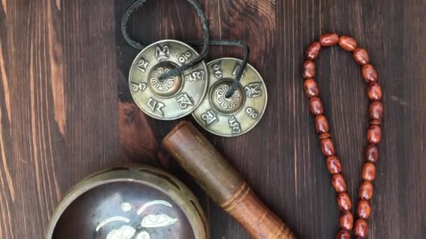 Items for religious ritual: singing bowl, a drum beads, magic balls and percussion plate — Stock Video