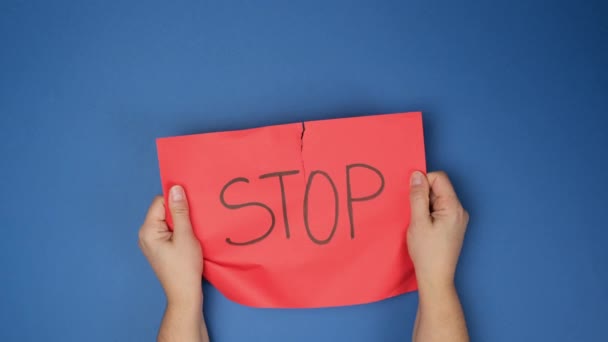 Female Hands Tearing Half Red Sheet Paper Inscription Stop Blue — Stock Video