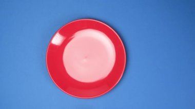 Eller kırmızı seramik plaka yeşil ölçüm bandı, kilo kaybı konsepti, üst görünüm.