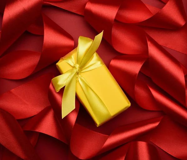 Gift Box Packed Yellow Paper Curled Red Silk Ribbon Red Stock Picture