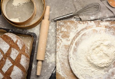 Yuvarlak ahşap bir tahtanın üzerine yığılmış beyaz buğday unu.