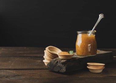 Cam bir kavanozda turta ve siyah arka planda turta, yakın plan.