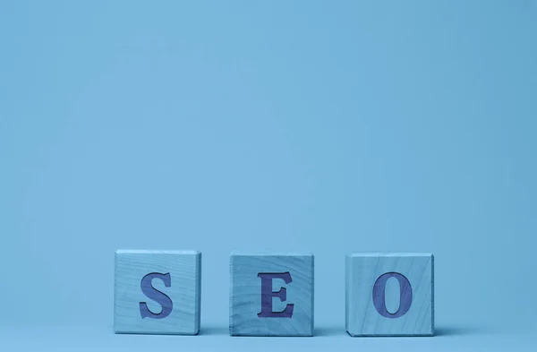 SEO inscription (search engine optimization) on wooden cubes. The concept of a set of measures for internal and external optimization to improve the position of the site in the results of search engines