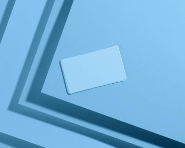 Yaratıcı mavi arkaplan üzerinde boş dikdörtgen kartvizit Gölgeli kağıt sayfalarından, üst görünüm