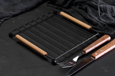 Boş metal ızgara, arka planda çatal ve bıçakla ızgara.
