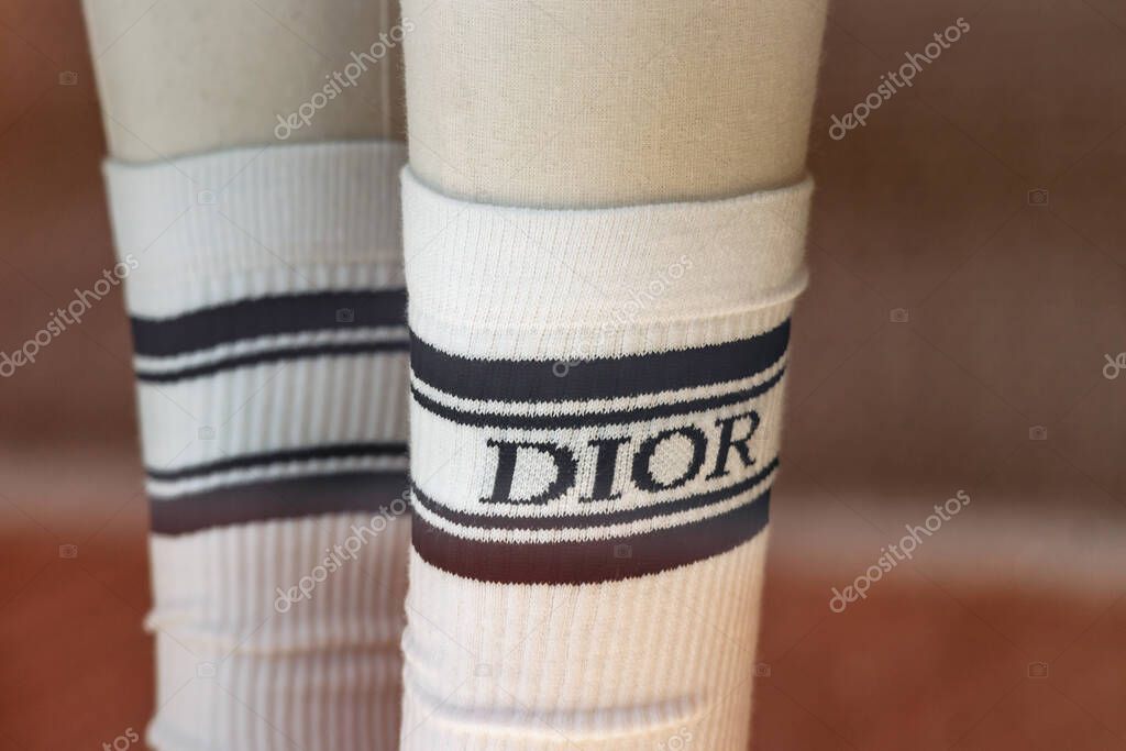 Monaco - June 28, 2025: Close-up of Dior socks and white sneakers displayed in the boutique window in Monte Carlo
