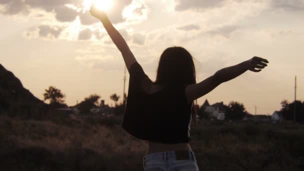 Chica silueta en pantalones cortos bailando durante la puesta del sol — Vídeos de Stock