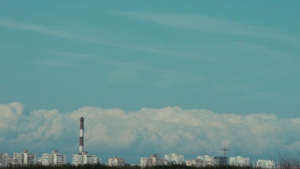 Sovjet-stijl gebouwen met de plant toren ver weg op de blauwe hemelachtergrond — Stockvideo