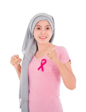 Asyalı kadınlar üstlerine pembe bir kurdele takarlar. Renkli arka planda pembe dambılları kaldırarak egzersiz yapıyorum. Göğüs kanseri kavramı, kanser önleme kavramı.