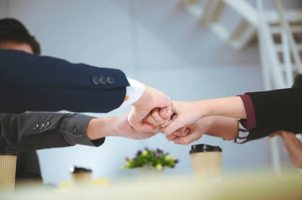 Business man in a suit shakes hands to agree a business partnership agreement. Business etiquette concept of congratulation, concept of handshake during office meeting.