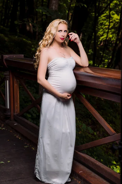 Pregnant blonde in white dress — Stock Photo, Image