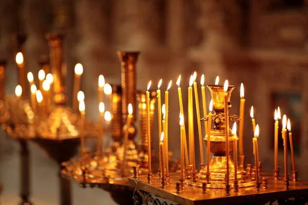 Many Long Burning candles during church service — Stock Photo, Image
