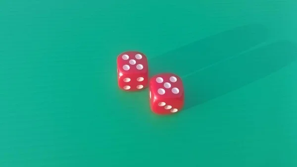 Pair of colorful dice placed on a bright green background.