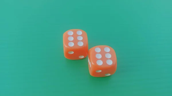 Pair of colorful dice placed on a bright green background.