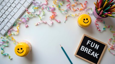 AI celebration flat lay concept showing a colorful festive workspace with cupcakes, smiley face cookies, confetti, ribbons, and decorations arranged around a white background with a keyboard. 