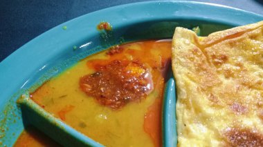 The scene captures a typical local breakfast setting with simple tableware and casual ambiance, representing Malaysian street food culture.