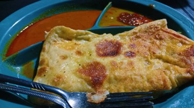 The scene captures a typical local breakfast setting with simple tableware and casual ambiance, representing Malaysian street food culture.