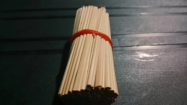 The simple composition and contrast between light wood and dark background create a clean and minimal aesthetic suitable for concepts like craft, material, or everyday objects.