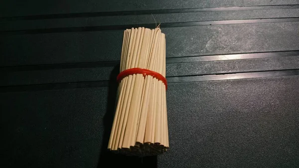 The simple composition and contrast between light wood and dark background create a clean and minimal aesthetic suitable for concepts like craft, material, or everyday objects.