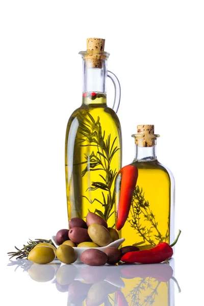 Bottles of Olive Oil with Pepper and Herbs on White — Stock Photo, Image