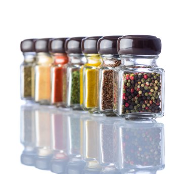 Beyaz arkaplandaki kavanozlardaki baharatlar