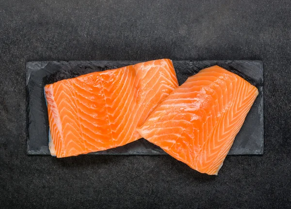 Kırmızı somon balık fileto ham kara tahta üzerinde — Stok fotoğraf
