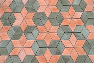 Kaldırımlar, patika, güzel modern kaldırım levhalarından yapılmış yol, geometrik desenler. Soyut gri turuncu arka plan, çimento taş levhaları dokusu. Döşeme, cadde, ev için malzeme yakın çekim