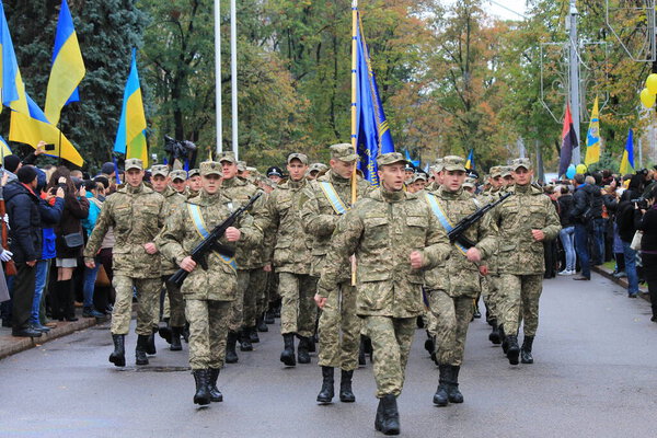 Military parade in Ukraine. A line of soldiers of Ukrainian army with weapons and flags is parade on Defender Day. Dnipro city, Dnepropetrovsk, Ukraine, 14 10 2019