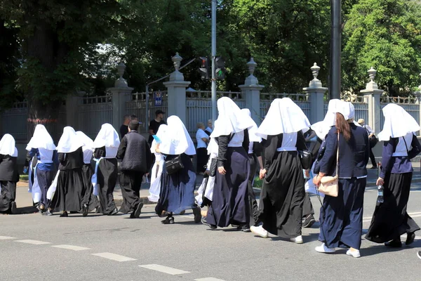 A group of nuns in church clothes are walking down the street in city Kyiv. Religious women, parishioners of the Orthodox Church walk in Kiev, Ukraine